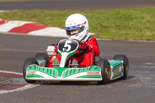 Students enjoying a go-karting activity during the autumn term, showcasing their racing skills and excitement.