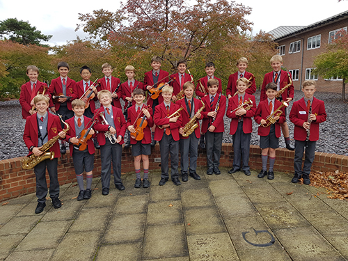 Students participating in a music activity, playing musical instruments and showcasing their musical talents