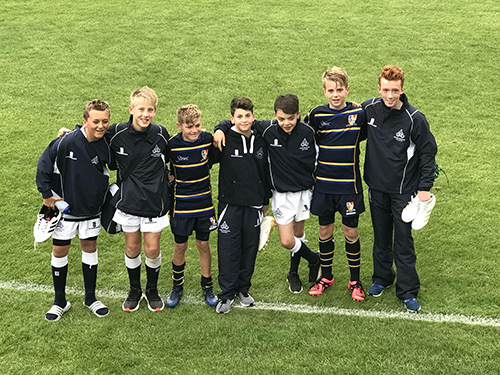 Students participating in a rugby match as part of the Old Moles Rugby Club, demonstrating their rugby skills and sportsmanship