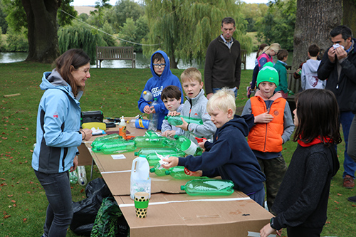 Students and adults are having food after the 4th Moulsford Mudder 