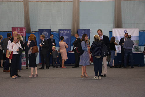 A group of adults are talking to each other at an event