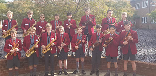 Students participating in a music event at Radley College, showcasing their musical talents and enjoying a collaborative performance