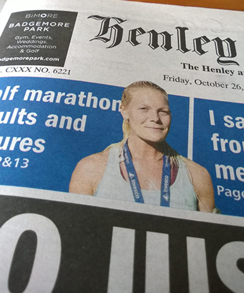 A piece of newspaper displays news about the Henley Half Marathon