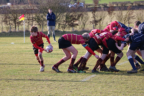 Students engaging in a rugby match, demonstrating their skills and teamwork on the field