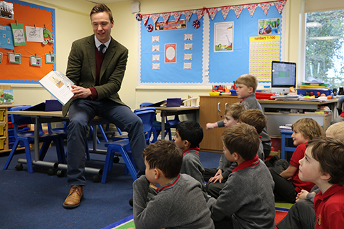 A teacher reading a story to a class of pre-prep students