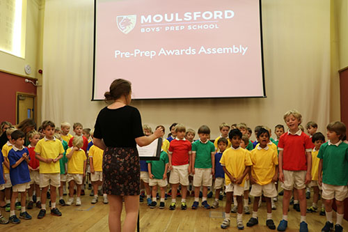 Preparatory school students receiving awards during a special ceremony, acknowledging their accomplishments and efforts in various areas